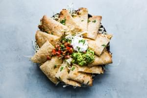 platter of chicken quesadilla triangles served with sour cream, guacamole and pico de gallo