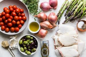 Ingredients laid out for baked chicken thighs with asparagus recipe.