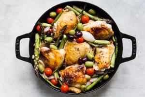 Baked Chicken Thighs With Asparagus, cherry tomatoes, shallots and olives in a white wine dijon sauce.