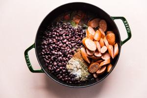 peppers, onion, black beans smoked sausage, stock and spices in a large soup pot
