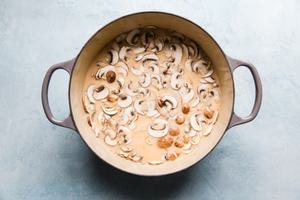 Coconut Chicken Soup Tom Kha Gai with mushrooms in a soup pot