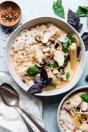 Coconut Chicken Soup Tom Ka Gai with two spoons and a linen