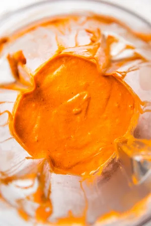 blender filled with blended roasted red pepper sauce