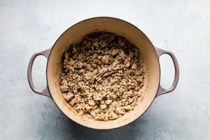 ground chicken and spices in a soup pot