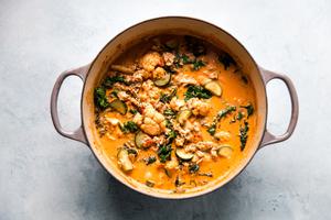 Creamy Tomato And Vegetable Soup With Italian Chicken Sausage in a soup pot
