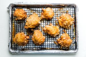 baking sheet with crispy bone in skin on chicken thighs