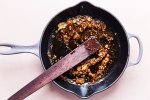 stir fry sauce in a sauce pan with a wooden spoon