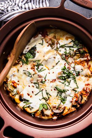 finished vegetarian lasagna with basil and parmesan cheese with serving spoon
