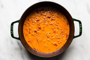 a pot of homemade vodka sauce made with onion, pancetta, vodka, garlic, tomatoes, salt, cream and Parmesan