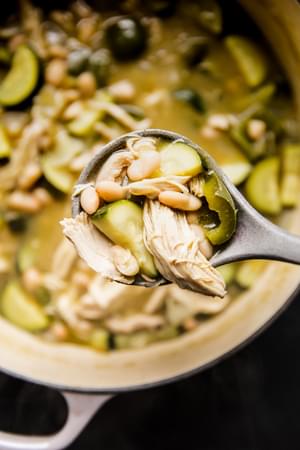 A ladle with Green Chicken Enchilada Soup