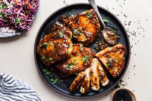 Hoisin Glazed Pork Chops on a plate with a spoon