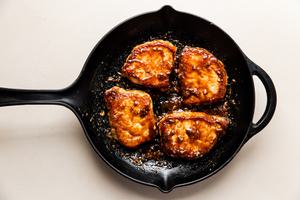 4 Hoisin Glazed Pork Chops in a cast iron skillet
