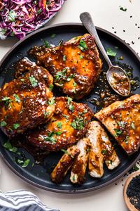 Hoisin Glazed Pork Chops on a plate with a spoon
