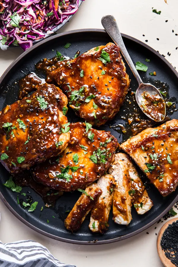 Hoisin Glazed Pork Chops on a plate with a spoon