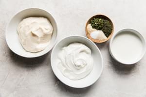 Spices, buttermilk, mayo, and garlic, all gathered to create the perfect creamy, tangy homemade ranch dressing.