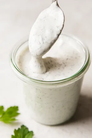 Creamy homemade ranch dressing in a glass jar, ready to elevate any dish with its fresh, herb-infused flavor.
