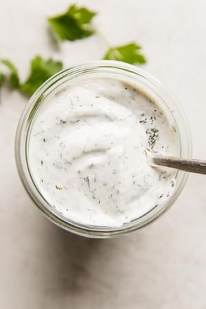 Creamy homemade ranch dressing in a glass jar, ready to elevate any dish with its fresh, herb-infused flavor.