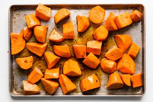 cubed honey roasted sweet potatoes on a baking sheet