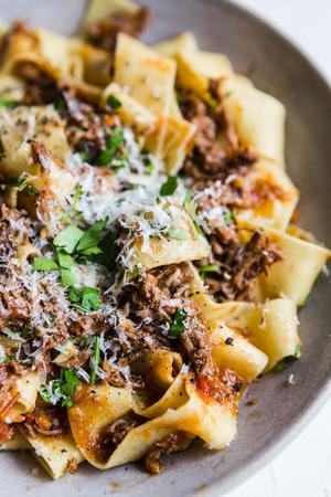close up of homemade beef ragu over pasta