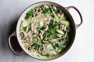 large pot of turkey soup with shallots, garlic, ginger, chicken stock, bok choy, mushrooms, fish sauce and rice noodles