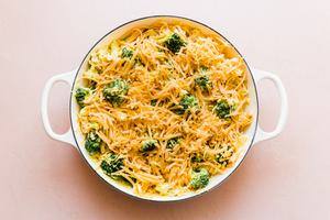 broccoli, shredded chicken, cheddar cheese, chicken divan in a pan