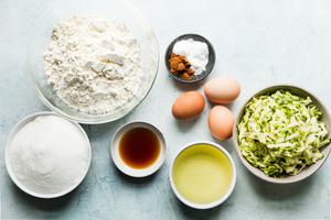 ingredients for zucchini mufffins in small bowls