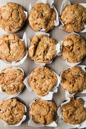 muffin pan with moms zucchini muffins in parchment paper