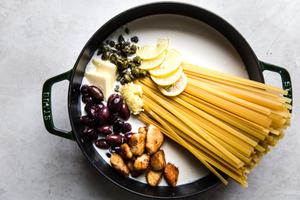 ingredients in a soup pot, butter, cream, chicken, pasta, olives