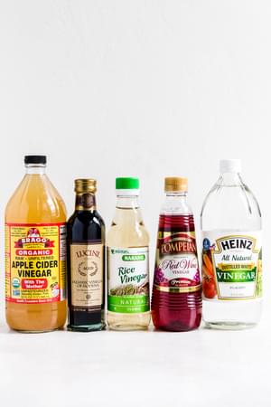 Bottles of apple cider vinegar, balsamic vinegar, rice vinegar, red wine vinegar and white vinegar