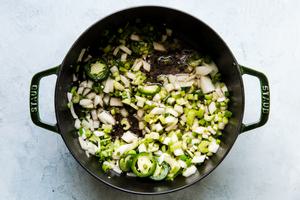 cooked bacon with diced onions and jalapeños in a dutch oven