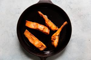4 four ounce salmon fillets cooked in a cast iron pan