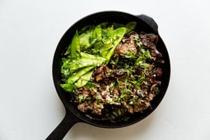 Steak And Snap Pea Garlic Butter Stir Fry in a cast iron pan