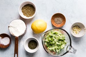 Greek yogurt, cucumber, dill, garlic, lemon juice, salt, pepper & za'atar in prep bowls to make tzatziki sauce