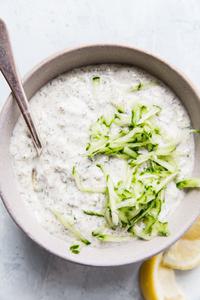 a bowl of tzatziki sauce made with Greek yogurt, cucumber, dill, garlic, lemon juice, salt, pepper & za'atar