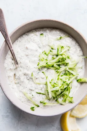 a bowl of tzatziki sauce made with Greek yogurt, cucumber, dill, garlic, lemon juice, salt, pepper & za'atar