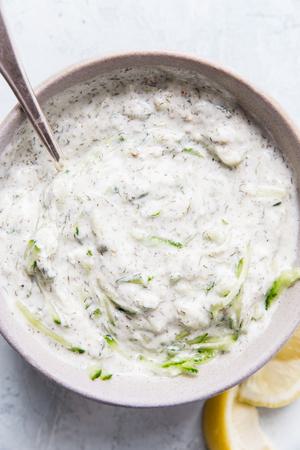 a bowl of tzatziki sauce made with Greek yogurt, cucumber, dill, garlic, lemon juice, salt, pepper & za'atar