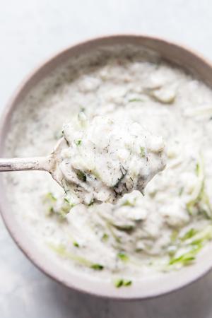 a bowl of tzatziki sauce made with Greek yogurt, cucumber, dill, garlic, lemon juice, salt, pepper & za'atar