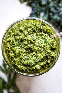 walnut kale vegan pesto in a glass jar with a spoon