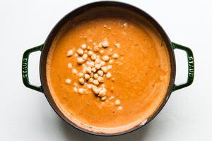 chickpeas being added to african peanut stew