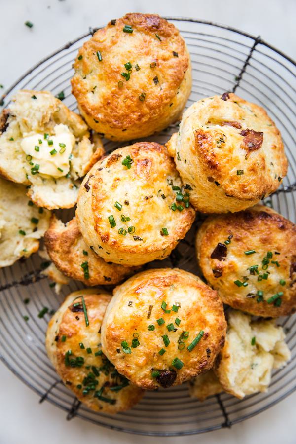 bacon cheddar buttermilk biscuit recipe with chives and butter on a wire baking rack