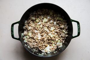 browned ground sausage, onion and garlic in a Dutch oven