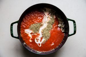 marinara, Italian seasoning, cream and ground sausage in a dutch oven