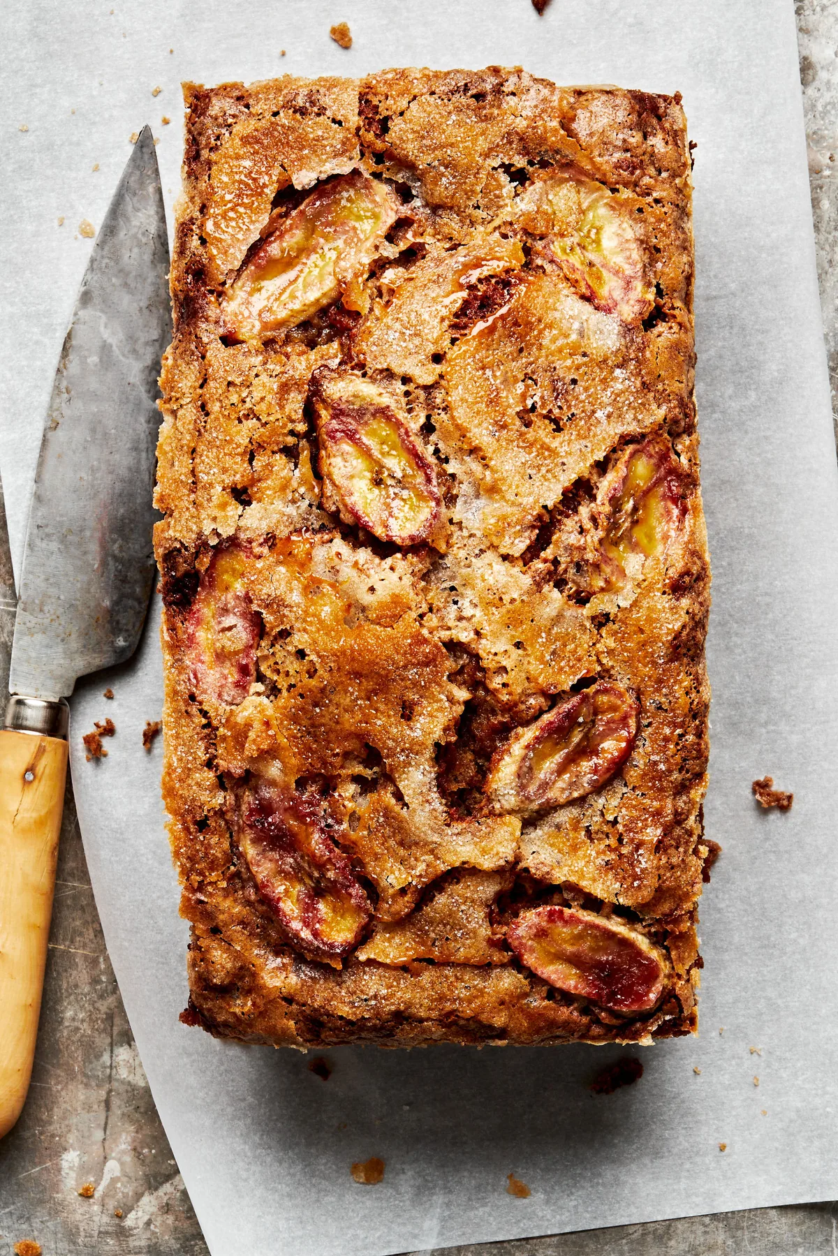 homemade banana bread topped with thinly sliced bananas and sprinkled with sugar in a list of the best baked breakfast ideas
