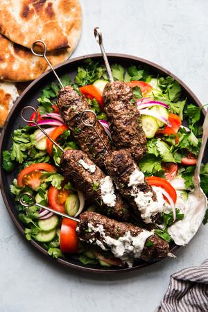 Beef Kofta Kababs with Tzatziki pita bread tomatoes on skewers