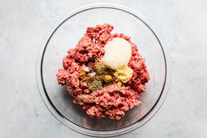 ingredients for kofta, ground beef onion, garlic, spices in a bowl
