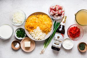 ingredients for Beer Cheese Soup grated pepper jack and cheddar cheese, bacon, green onions, bell peppers cream and onion