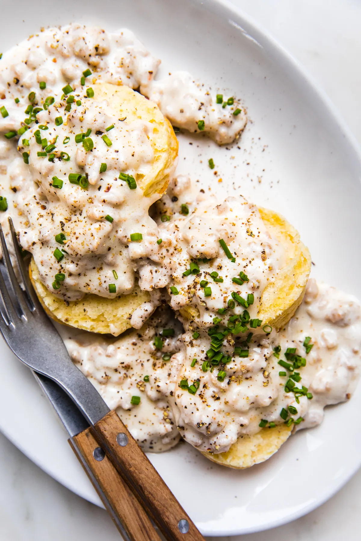 homemade biscuits smothered in creamy gravy in a list of the best breakfast recipe ideas
