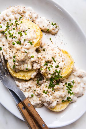 homemade biscuits smothered in creamy gravy in a list of the best breakfast recipe ideas