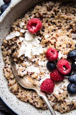 breakfast quinoa made with coconut milk, maple syrup, vanilla, salt and fresh berries in a bowl