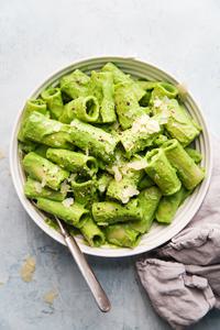 Rigatoni pasta with broccoli pesto in a bowl with a spoon